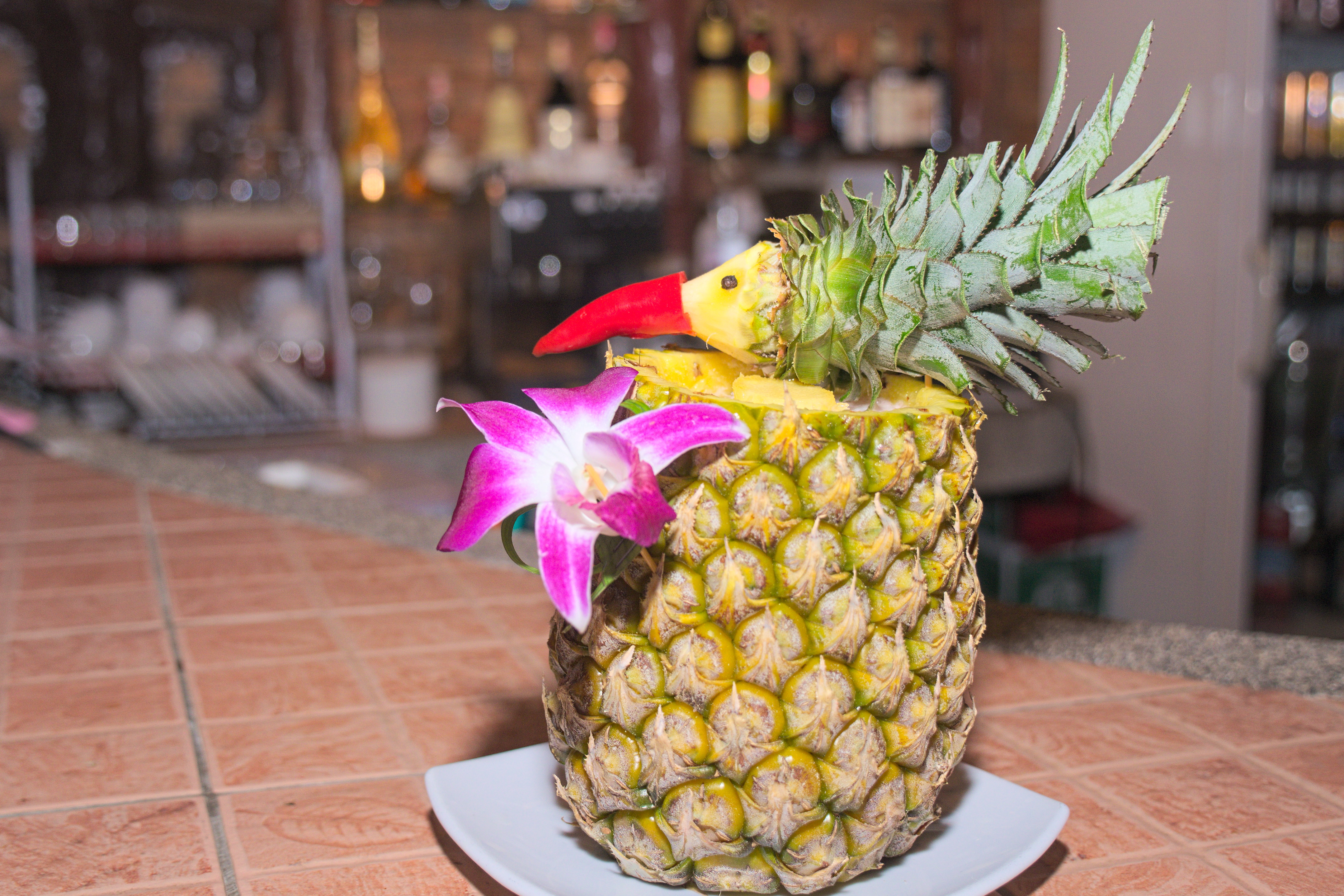 photo of mai tai cocktail served in fresh pineapple fruit