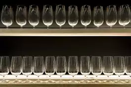 A shelf of wine glasses in a restaurant